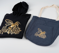 Black hoodie and blue tote bag featuring metallic gold puff vinyl designs, ideal for custom apparel and accessory decoration.