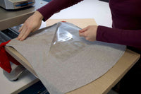 Applying heat transfer foil to a gray shirt