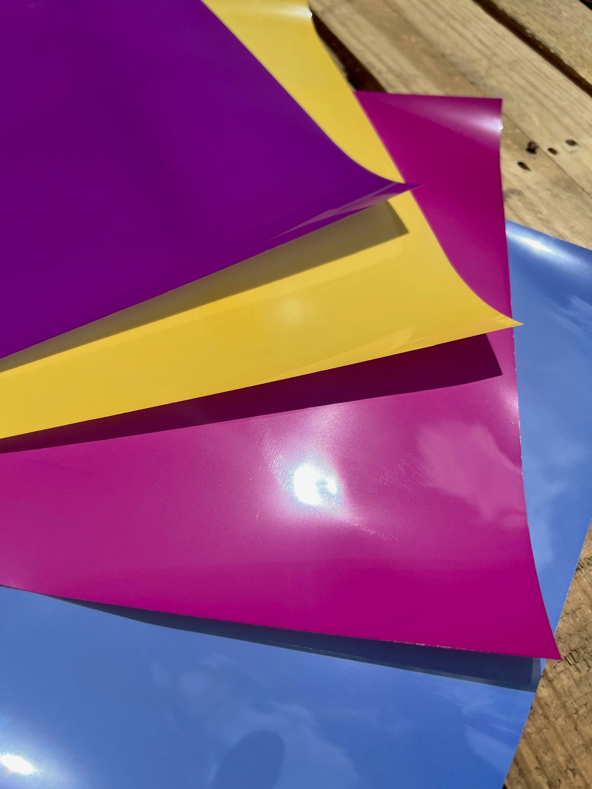 Colorful UV Shift vinyl sheets on wooden surface